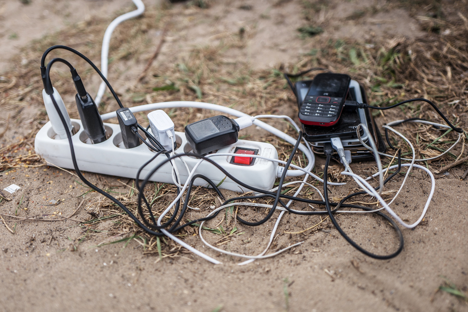 Mobile phones plugged in to charge from the generator on Eid.  Photograph: Rob Pinney for Point.51